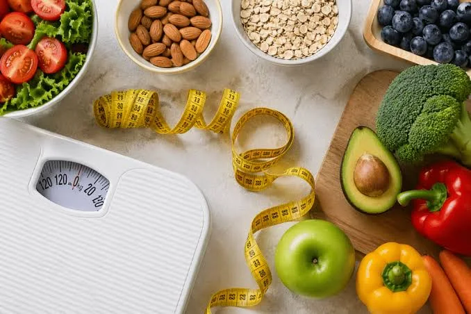 Báscula, cinta métrica y alimentos saludables